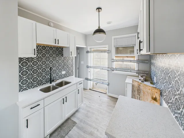 a kitchen with stainless steel appliances a sink stove and refrigerator