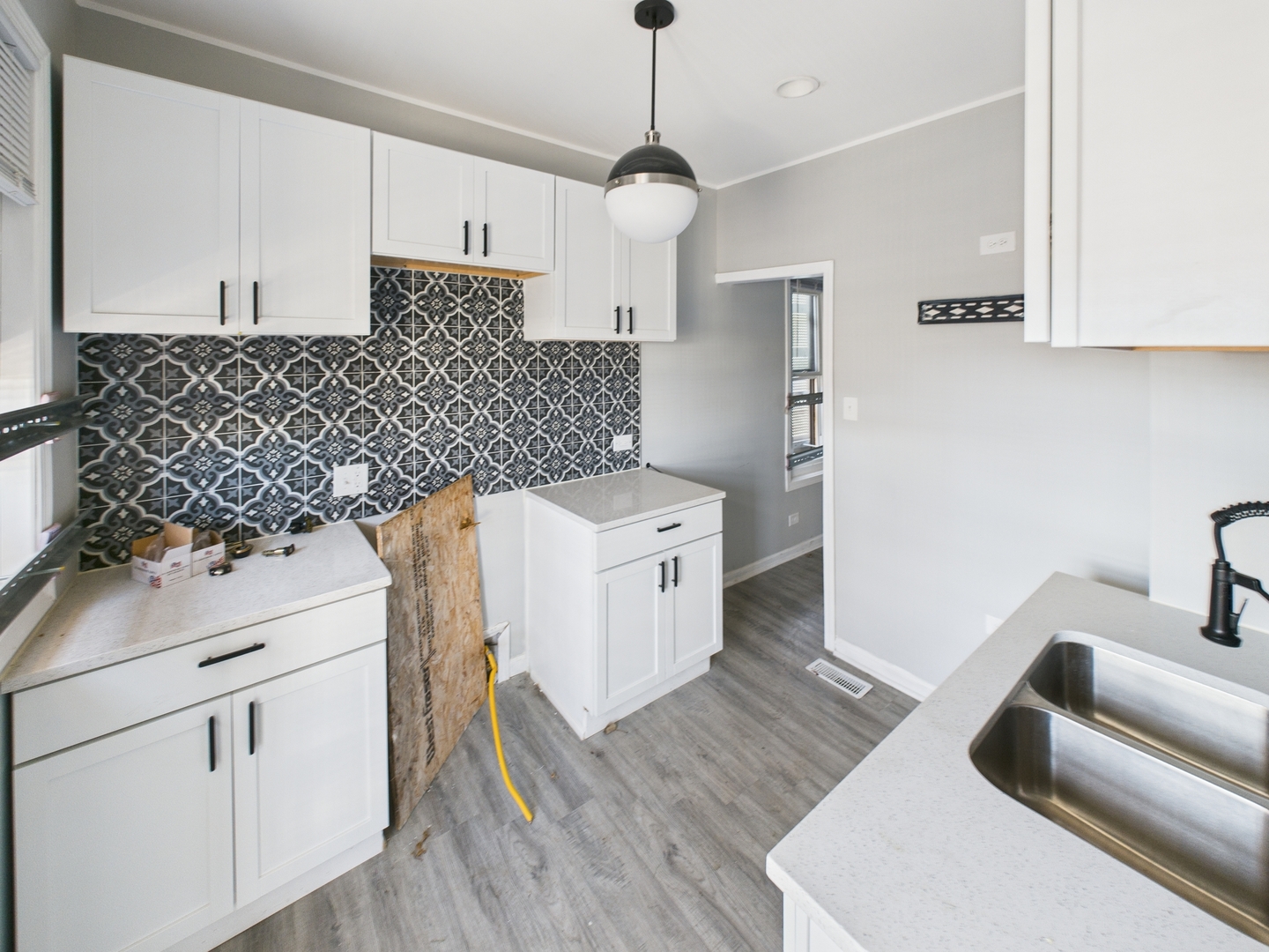 7425 South Perry Avenue Chicago, IL 60621 - Photo 13 of 16 a kitchen with a sink and wooden floor