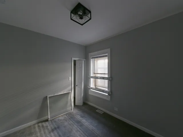 an empty room with a empty space and windows