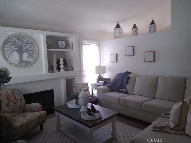a living room with furniture a rug and a fireplace