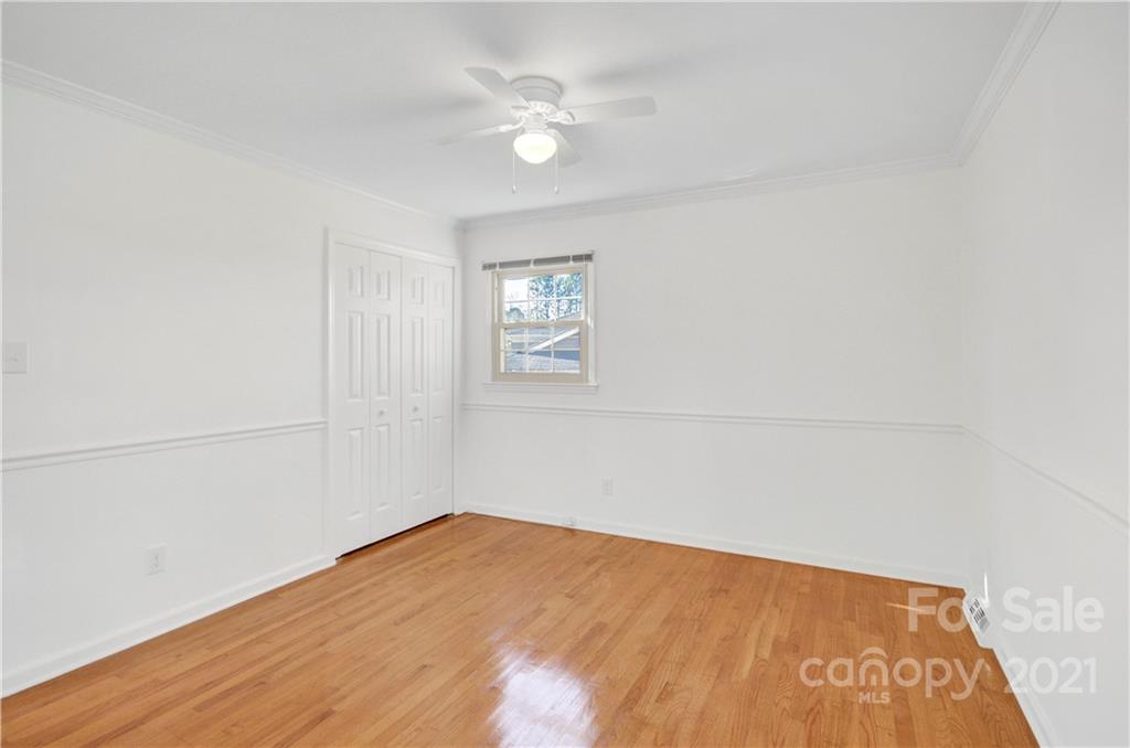 7243 Fox Hunt Road Charlotte, NC 28212 - Photo 11 of 34 an empty room with a window and ceiling fan