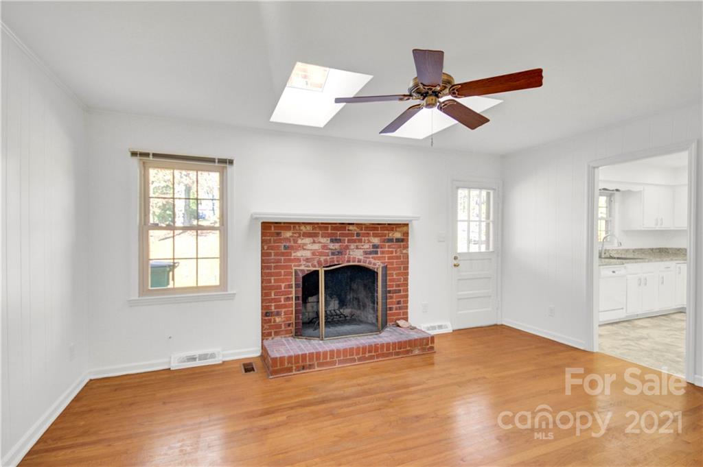 7243 Fox Hunt Road Charlotte, NC 28212 - Photo 16 of 34 a view of empty room with wooden floor and fan