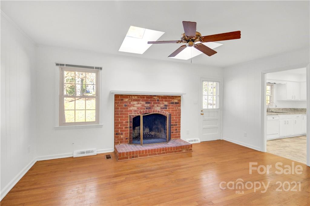 7243 Fox Hunt Road Charlotte, NC 28212 - Photo 17 of 34 a view of empty room with fireplace and fan