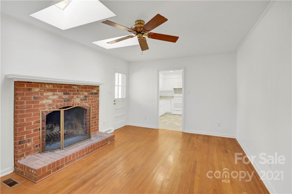 7243 Fox Hunt Road Charlotte, NC 28212 - Photo 18 of 34 a view of empty room with wooden floor and fireplace
