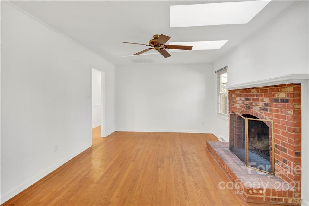 7243 Fox Hunt Road Charlotte, NC 28212 - Photo 19 of 34 a view of empty room with fireplace and fan