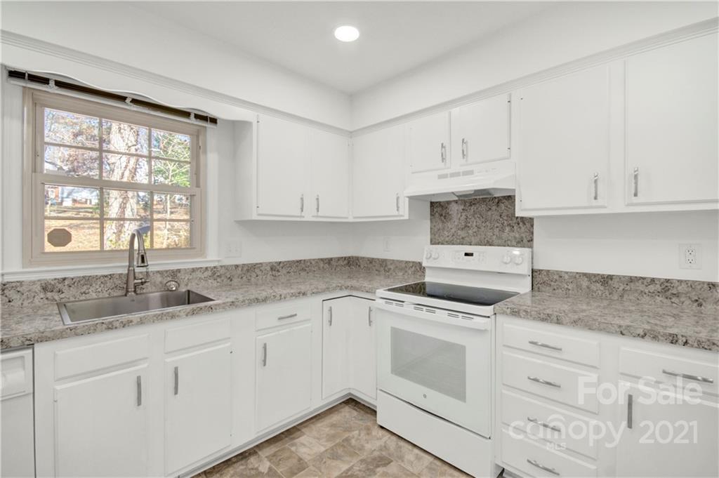 7243 Fox Hunt Road Charlotte, NC 28212 - Photo 20 of 34 a kitchen with granite countertop white cabinets and white stainless steel appliances with a sink
