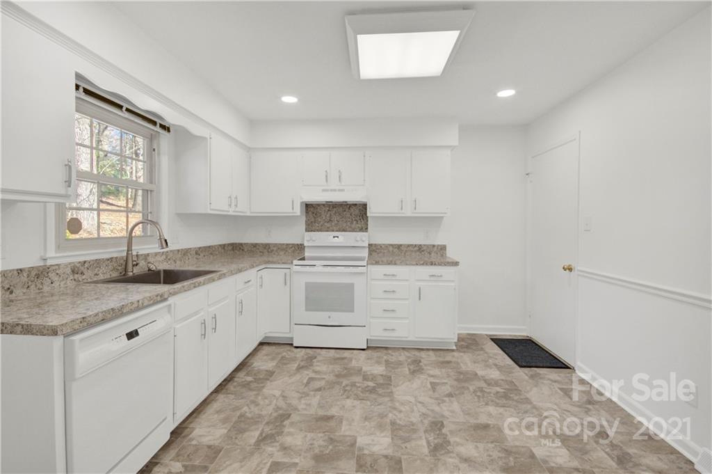 7243 Fox Hunt Road Charlotte, NC 28212 - Photo 21 of 34 a kitchen with granite countertop white cabinets and white appliances
