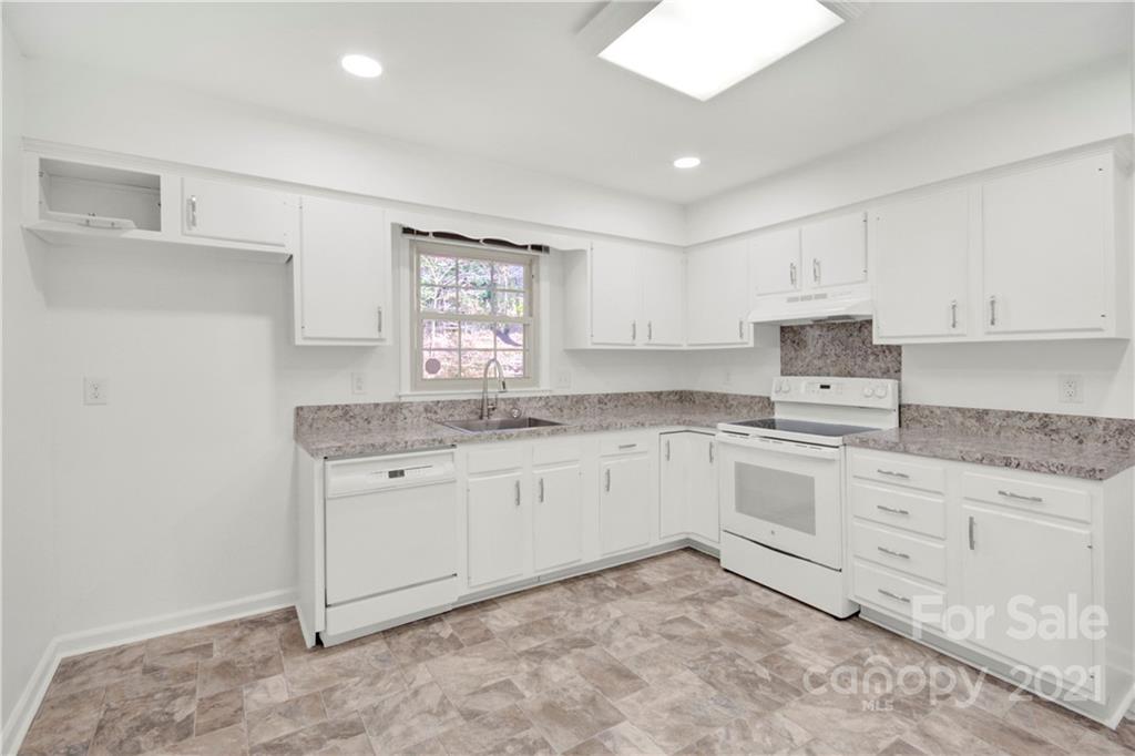 7243 Fox Hunt Road Charlotte, NC 28212 - Photo 22 of 34 a kitchen with granite countertop white cabinets white stainless steel appliances with a sink and dishwasher