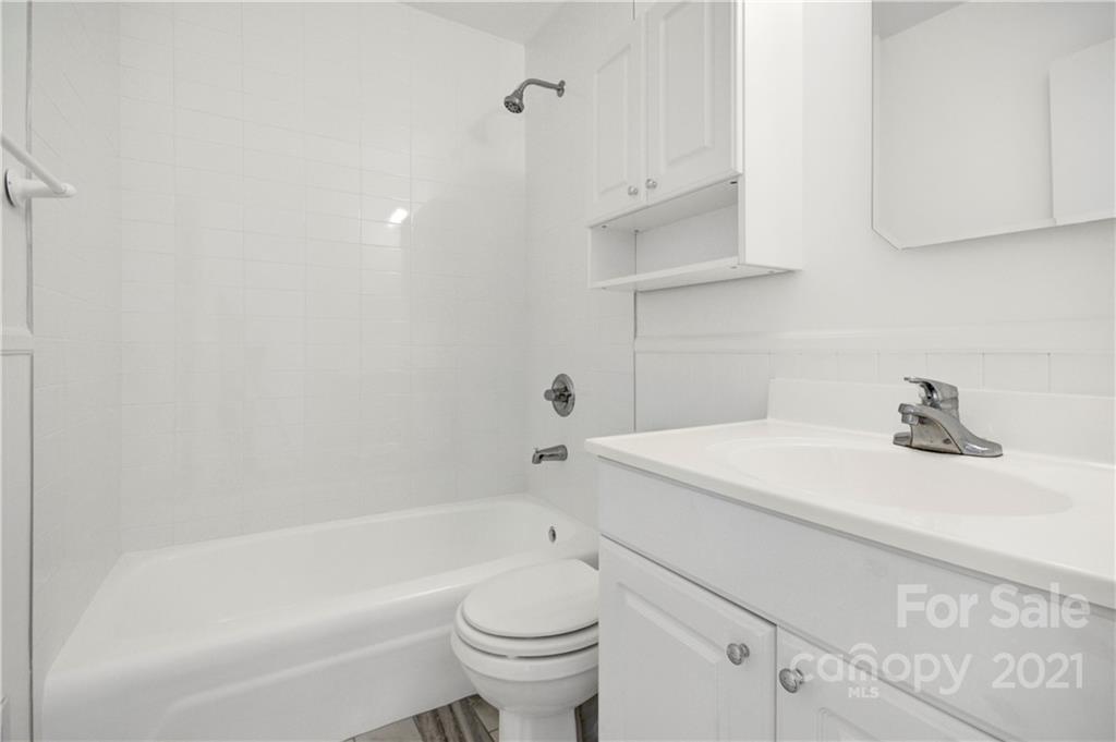 7243 Fox Hunt Road Charlotte, NC 28212 - Photo 24 of 34 a bathroom with a sink a toilet and shower