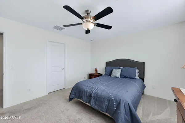 a bedroom with a bed and a television