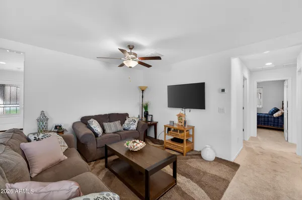 a living room with furniture and kitchen view