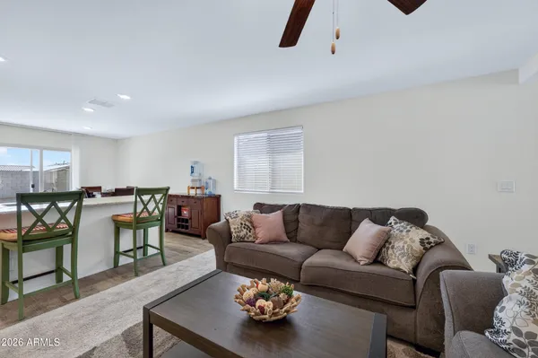 a kitchen with stainless steel appliances granite countertop a stove a refrigerator a kitchen island a table and chairs