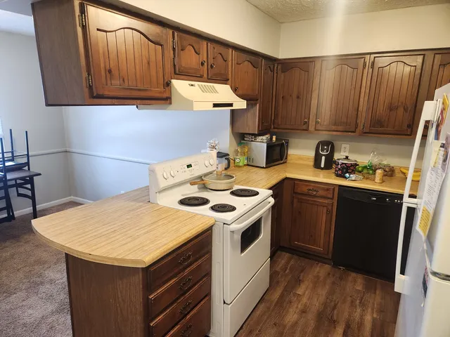 a kitchen with a sink a stove and cabinets