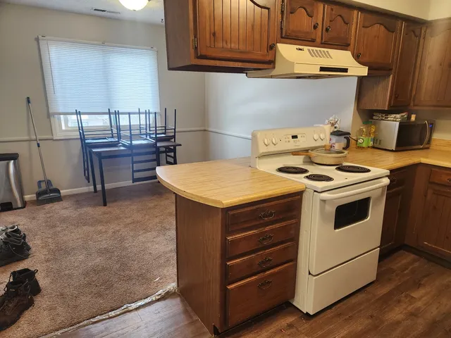 a kitchen with a stove and a cabinets