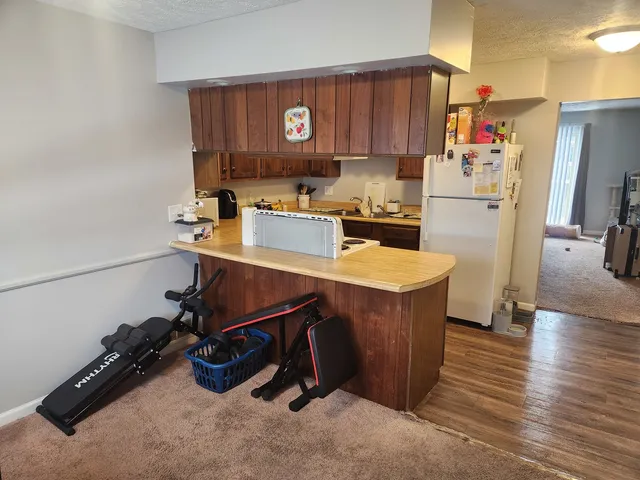 a room with wooden cabinets and appliances