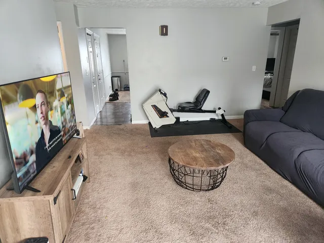 a living room with furniture and a flat screen tv