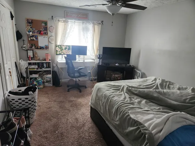 a bedroom with bed and window