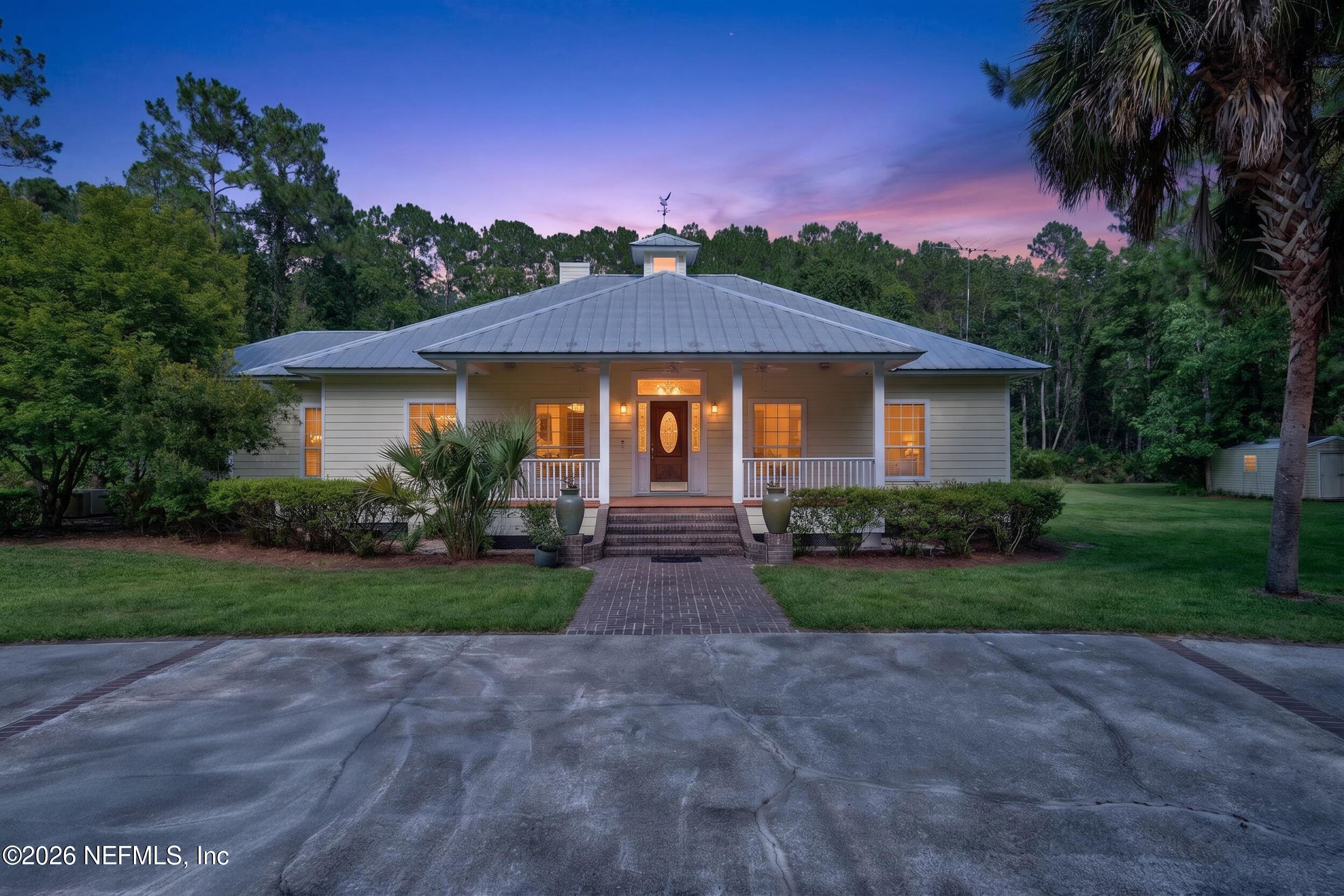 3090 Monument Bay Road St. Augustine, FL 32092 - Photo 1 of 56 a front view of a house with a yard and garage
