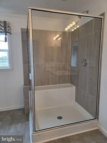 a bathroom with a shower and a tub