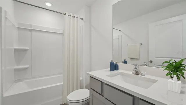 a bathroom with a sink a toilet and tub