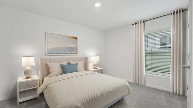 a bedroom with a bed and a night stand