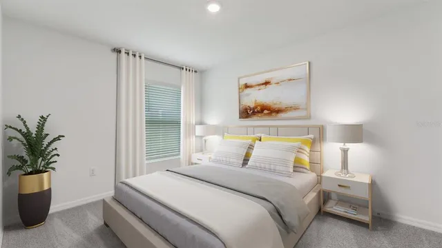 a bedroom with a bed and a potted plant