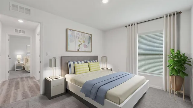 a bedroom with a large bed and a potted plant