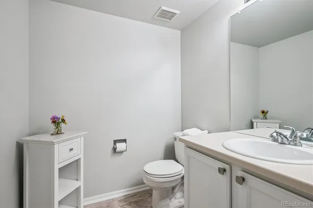 a bathroom with a sink toilet and a mirror