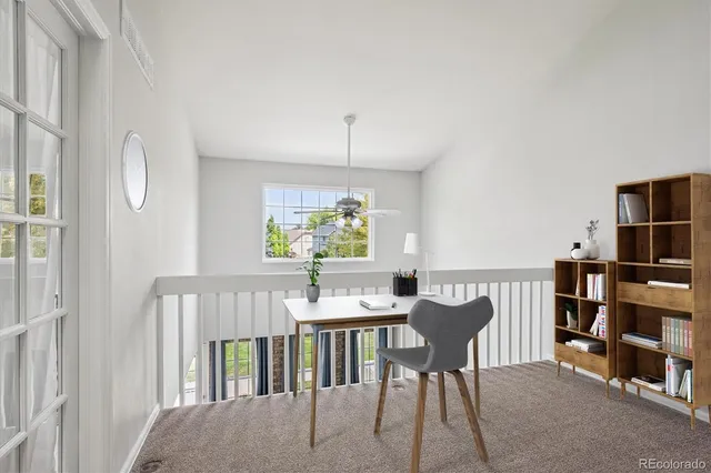 a view of a livingroom with furniture and staircase