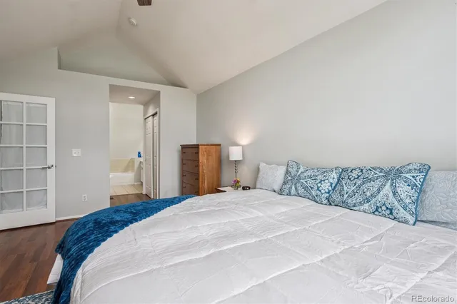 a bedroom with a large bed and a closet