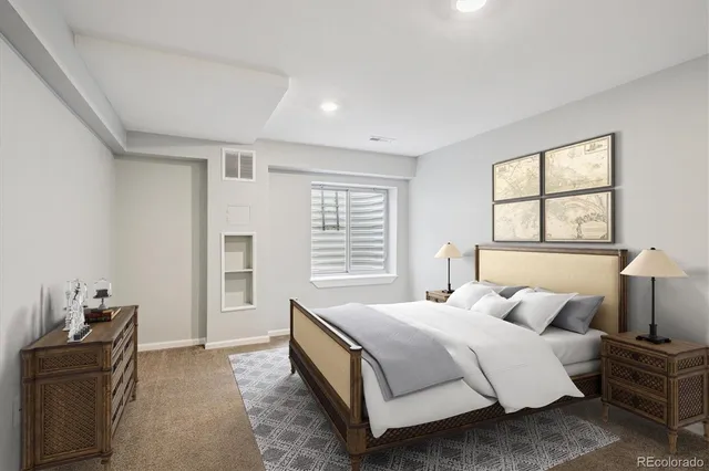 a spacious bedroom with a bed and wooden floor