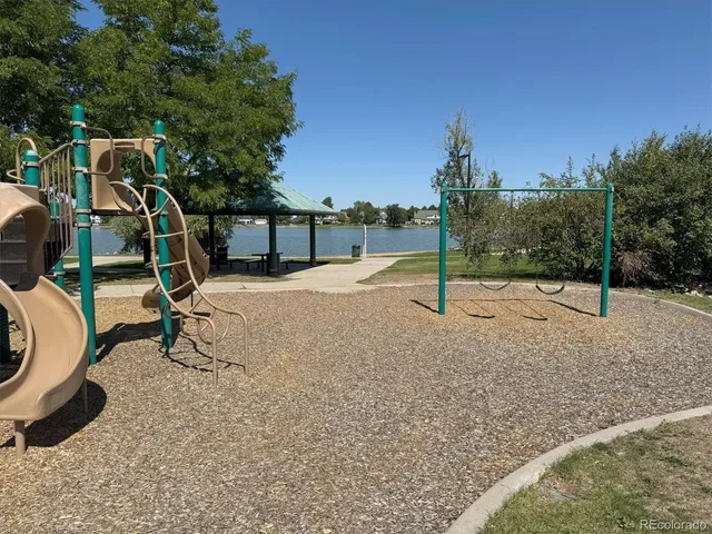 a view of a sign board with buildings in the background