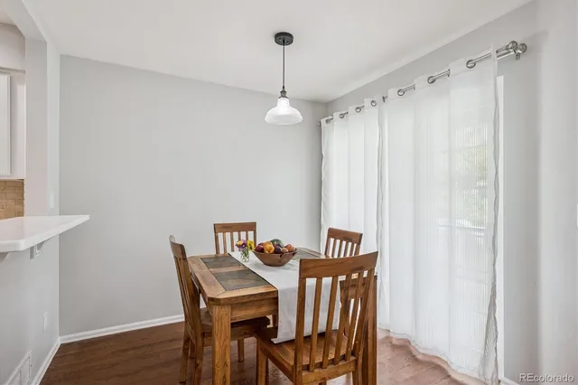 a view of a dining room with furniture window and wooden floor