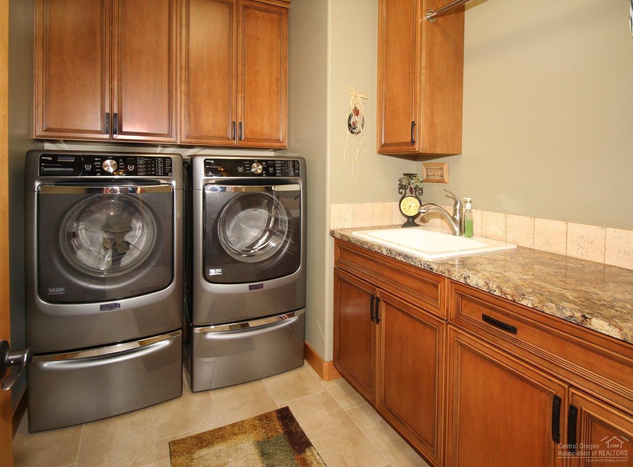 64534 Sylvan Loop Bend, OR 97701 - Photo 3 of 23 a view of a kitchen with washer and dryer