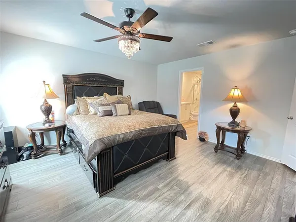 a bedroom with a bed and a chandelier