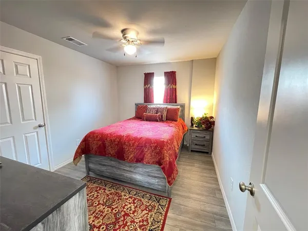 a bed room with a bed and a chandelier