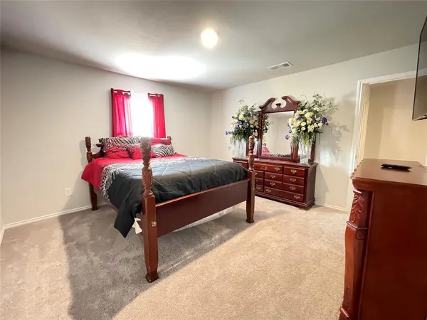 a bedroom with a bed and a chandelier