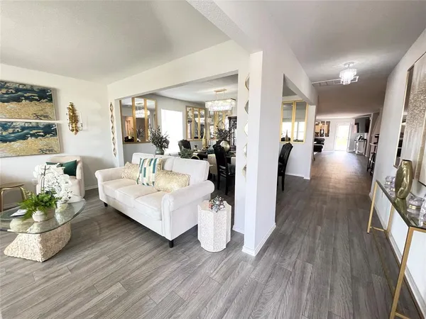 a living room with furniture and a wooden floor