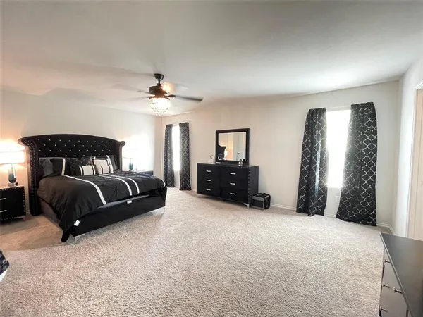 a bedroom with a bed lamp and a fireplace
