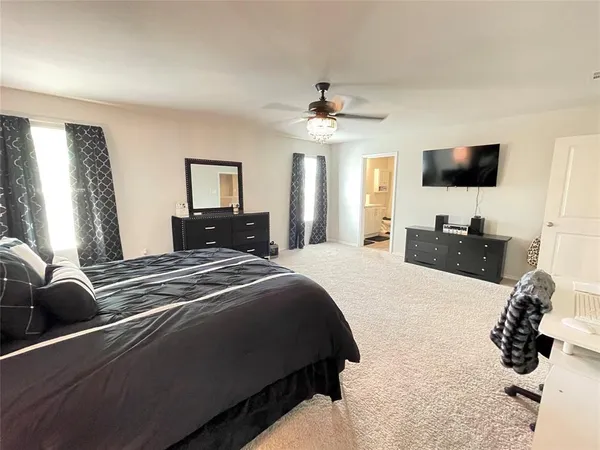 a bedroom with a bed and flat screen tv