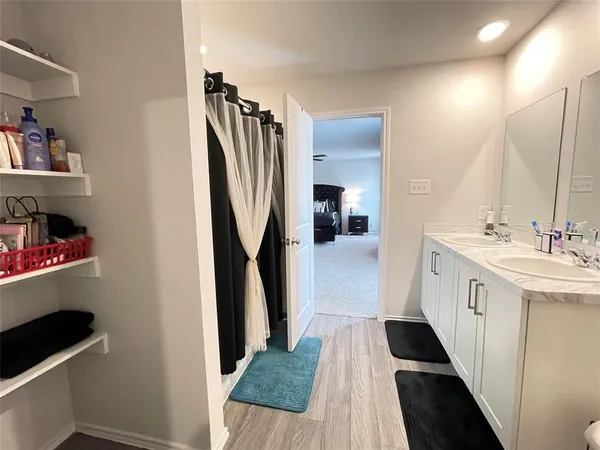 a bathroom with a sink a toilet and a mirror