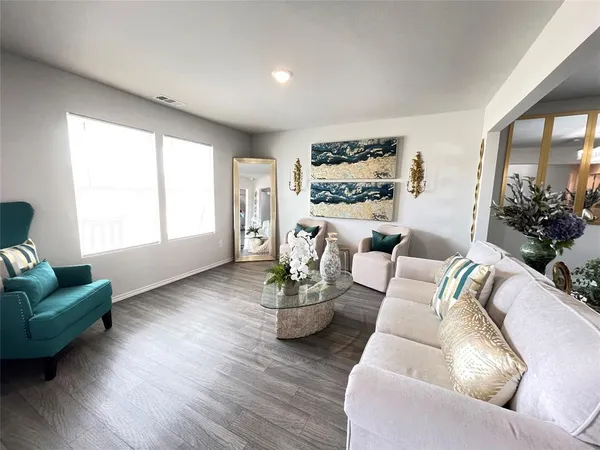 a living room with furniture and a large window