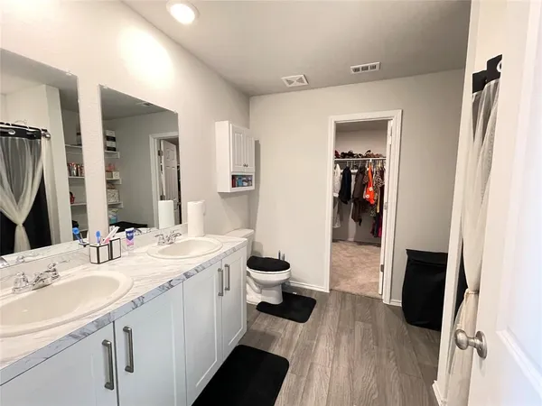 a bathroom with a double vanity sink and a mirror