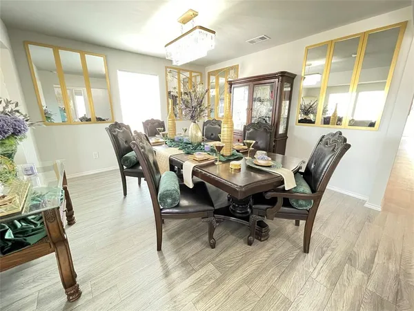a view of a dining room with furniture window and wooden floor