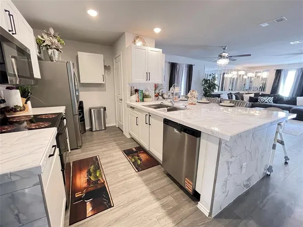 a kitchen with sink stove and cabinets
