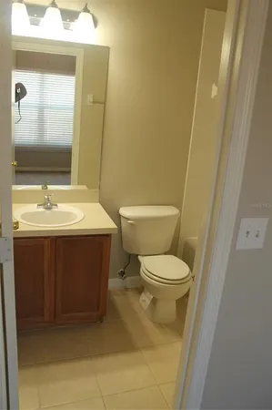 a bathroom with a sink toilet and mirror