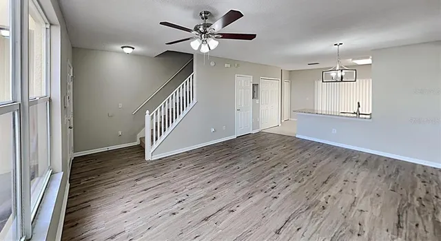 wooden floor in an empty room with a window