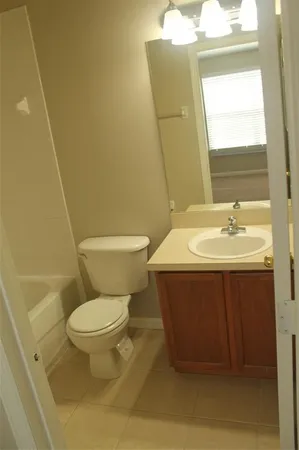 a bathroom with a sink toilet and mirror