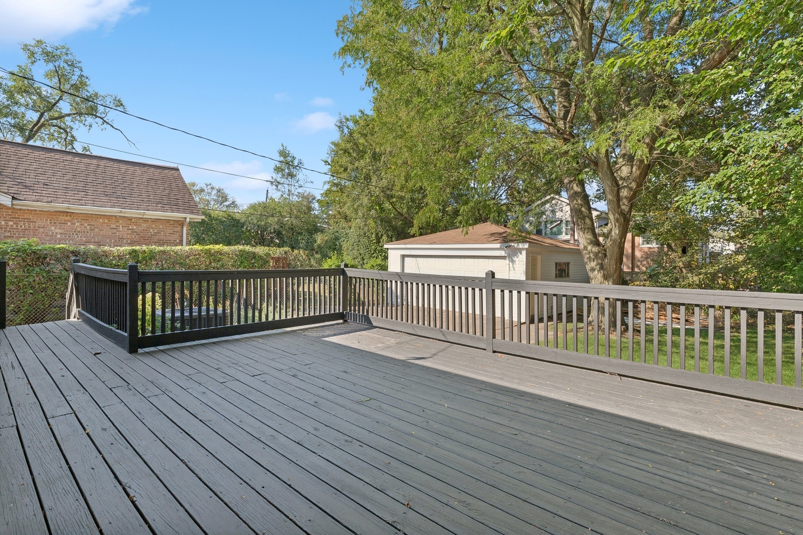 517 Romona Road Wilmette, IL 60091 - Photo 16 of 21 a view of a deck with wooden floor and fence