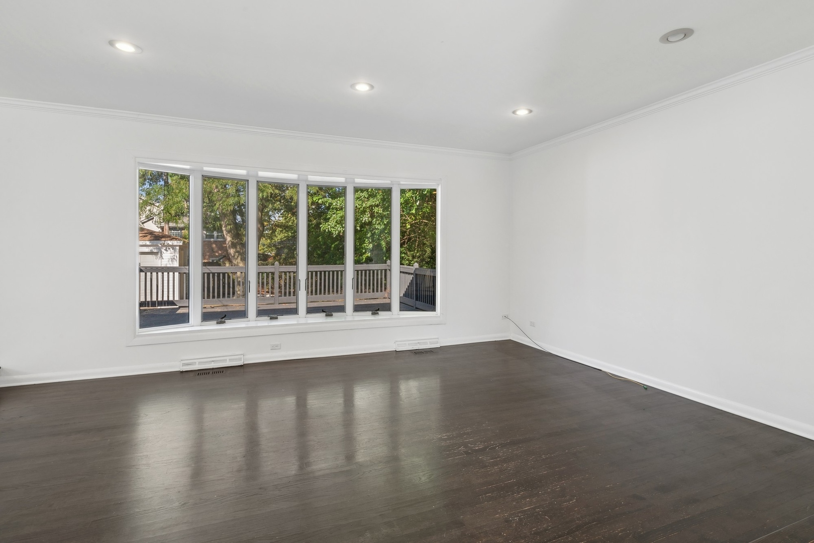 517 Romona Road Wilmette, IL 60091 - Photo 2 of 21 an empty room with wooden floor and windows